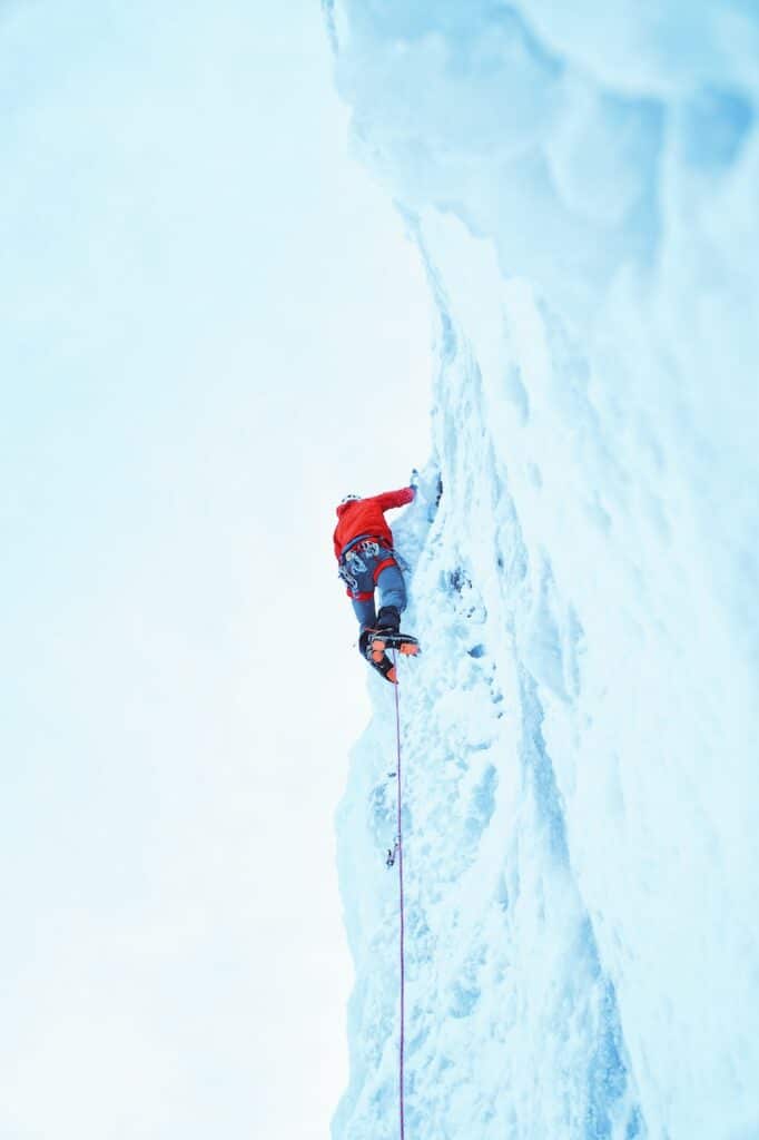 Ice climber wearing ice climbing boots and crampons