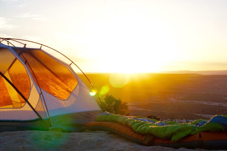 green sleeping bag, sunset, and tent