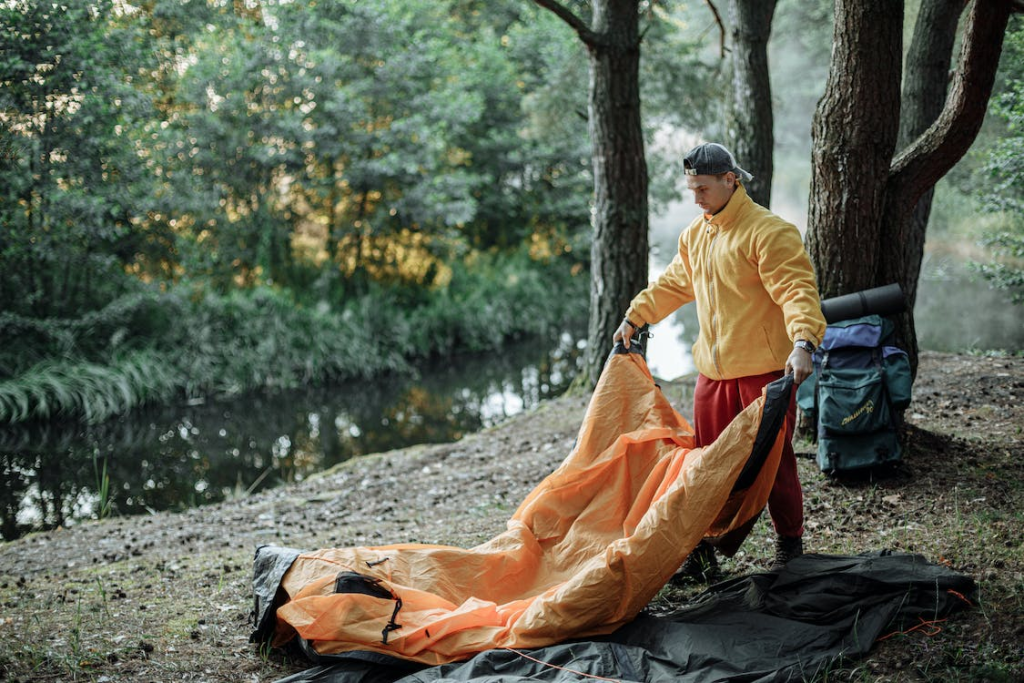 a camper setting up his tent