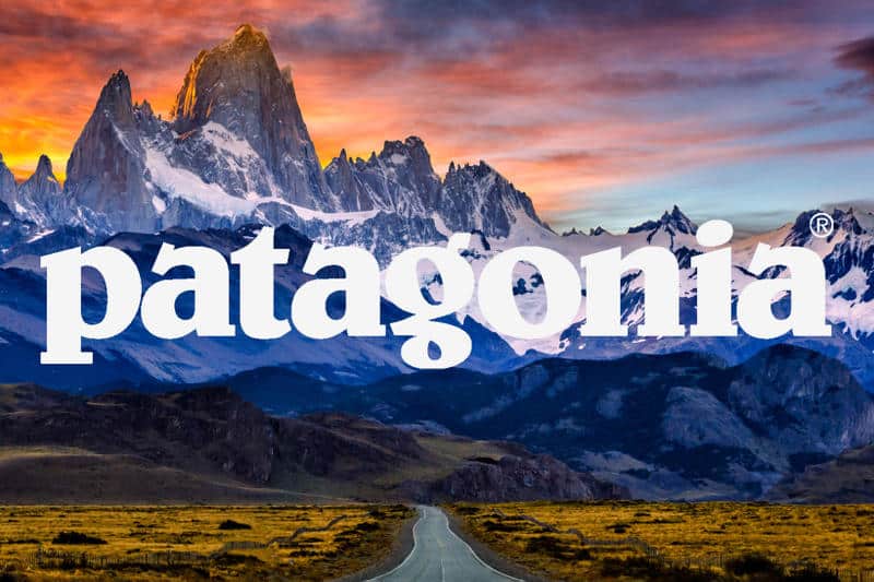 The word patagonia on a road with mountains in the background.